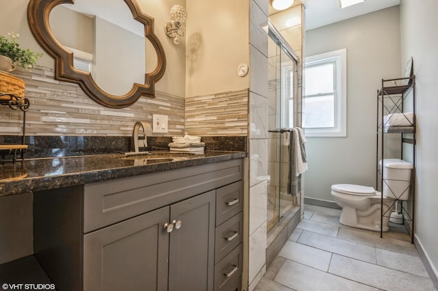 bathroom with backsplash, vanity, an enclosed shower, tile patterned floors, and toilet