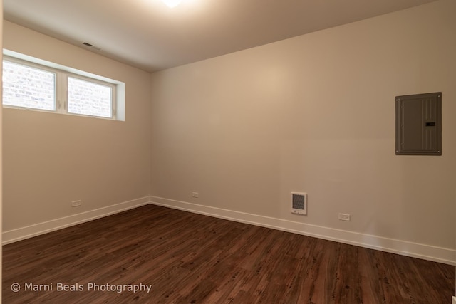 6517 S Saint Lawrence Ave, Chicago, IL 60637 - empty room featuring dark wood finished floors, electric panel, and baseboards