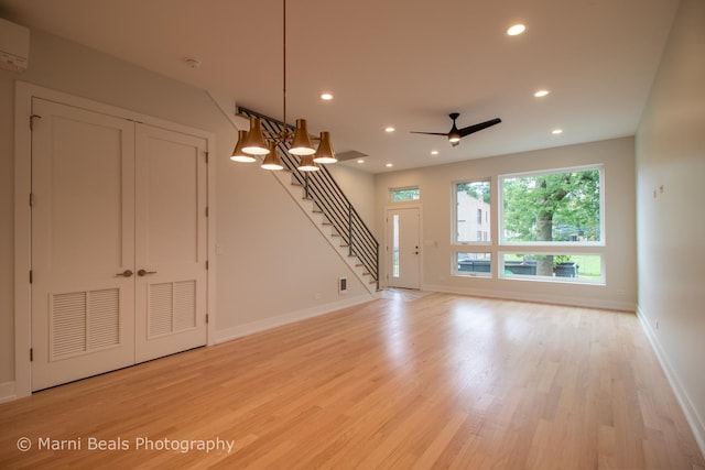 6517 S Saint Lawrence Ave, Chicago, IL 60637 - unfurnished living room with light wood-style floors, recessed lighting, baseboards, and stairs