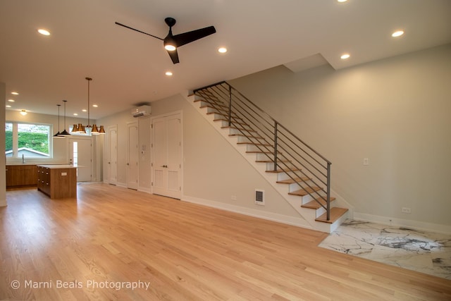 6517 S Saint Lawrence Ave, Chicago, IL 60637 - unfurnished living room with stairway, a ceiling fan, light wood finished floors, and baseboards