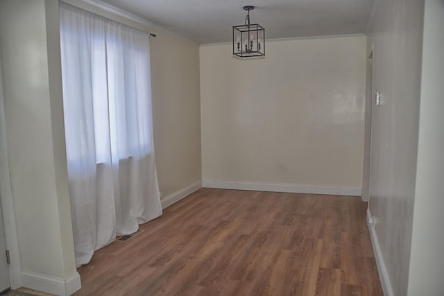 unfurnished dining area featuring hardwood / wood-style floors and an inviting chandelier