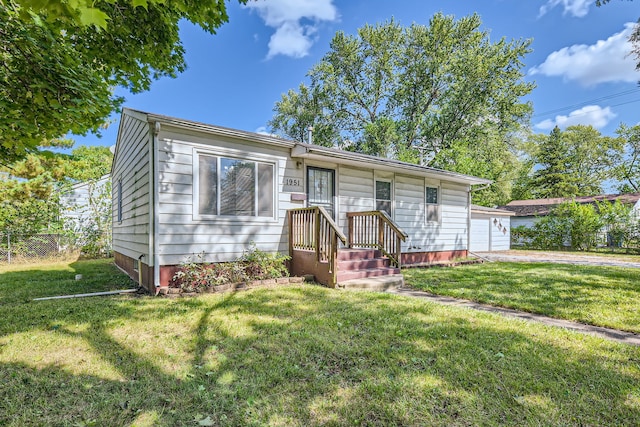 view of front of house with a front lawn and a garage