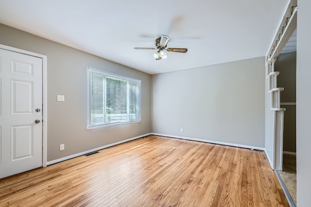 spare room featuring light wood-type flooring and ceiling fan