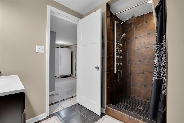 bathroom featuring a shower with curtain, vanity, and tile patterned flooring