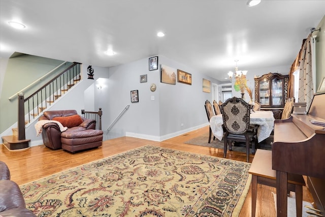 living room featuring light hardwood / wood-style flooring and a chandelier