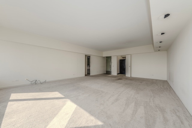 empty room featuring light colored carpet