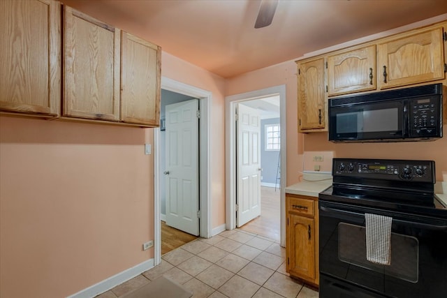 kitchen with black appliances, light brown cabinetry, ceiling fan, and light tile patterned floors