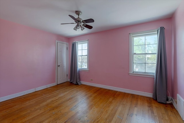 unfurnished room featuring light hardwood / wood-style flooring, ceiling fan, and plenty of natural light