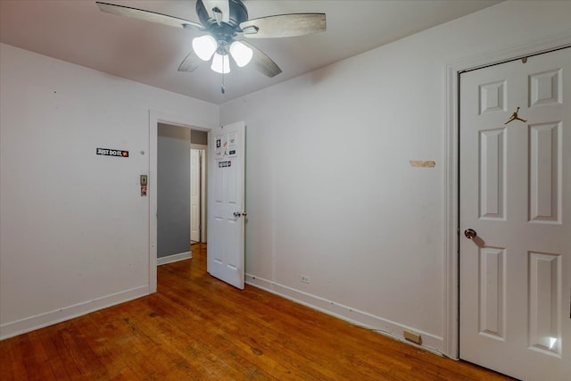 unfurnished bedroom with ceiling fan and wood-type flooring