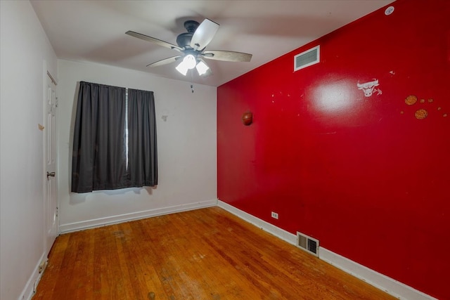 empty room featuring ceiling fan and hardwood / wood-style floors