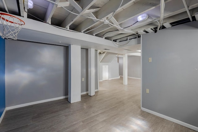 basement with hardwood / wood-style flooring