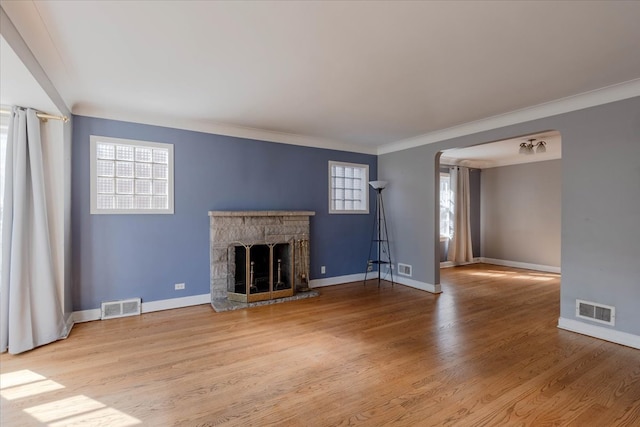 unfurnished living room with crown molding, a fireplace, and hardwood / wood-style floors