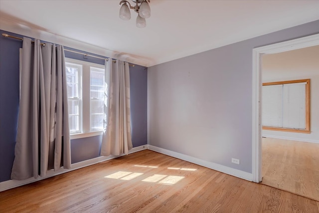 empty room with light hardwood / wood-style flooring