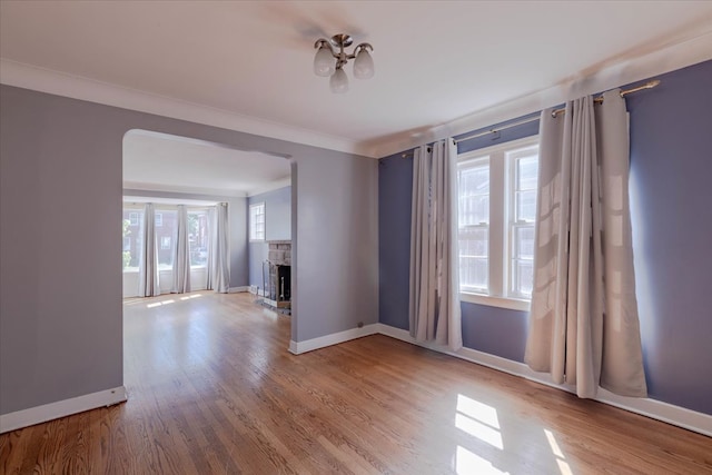 spare room featuring light hardwood / wood-style flooring and crown molding