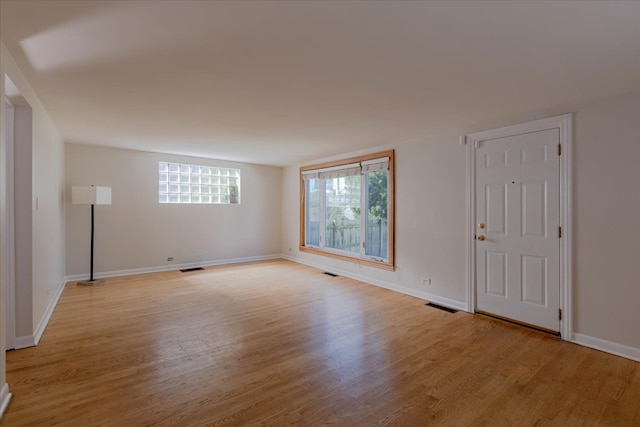 empty room with light hardwood / wood-style floors