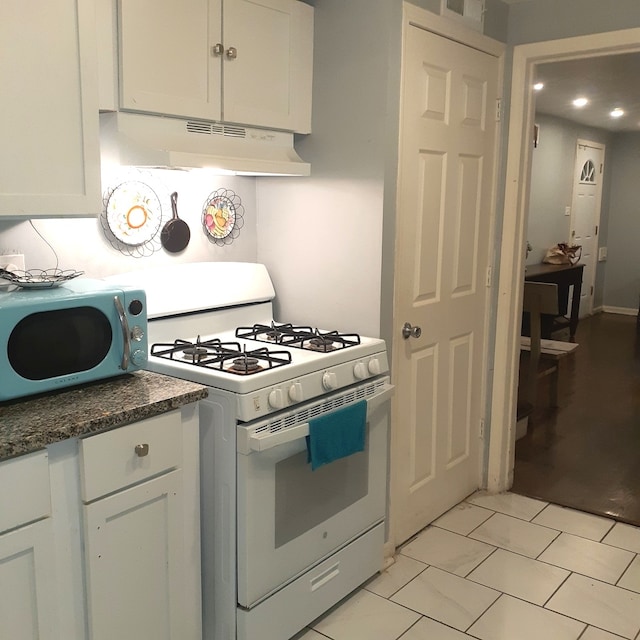 kitchen with white appliances and white cabinetry