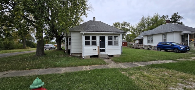 bungalow-style home featuring a front lawn