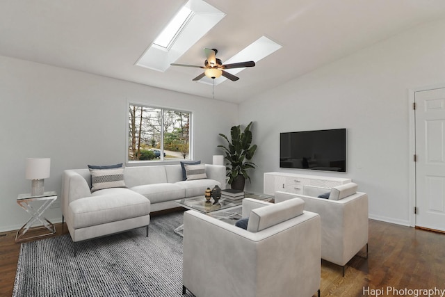 living room with dark hardwood / wood-style flooring, lofted ceiling with skylight, and ceiling fan