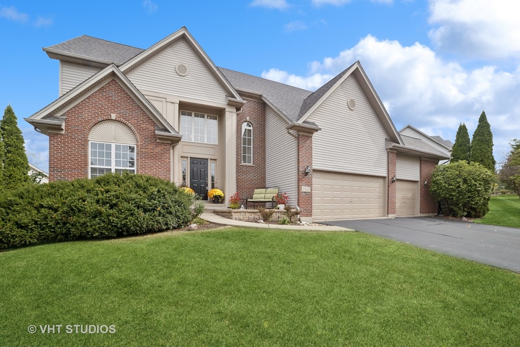 front of property with a front yard and a garage