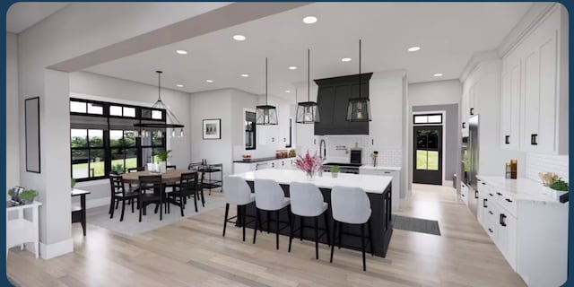 kitchen featuring white cabinets, backsplash, light hardwood / wood-style floors, and hanging light fixtures