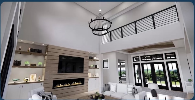 living room featuring a fireplace, a towering ceiling, and a chandelier