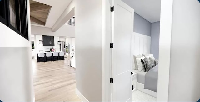 hallway with light hardwood / wood-style floors