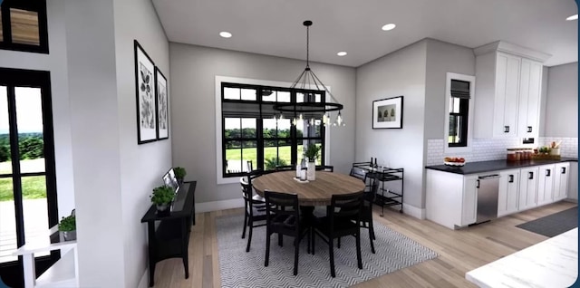 dining room featuring light hardwood / wood-style flooring and a notable chandelier