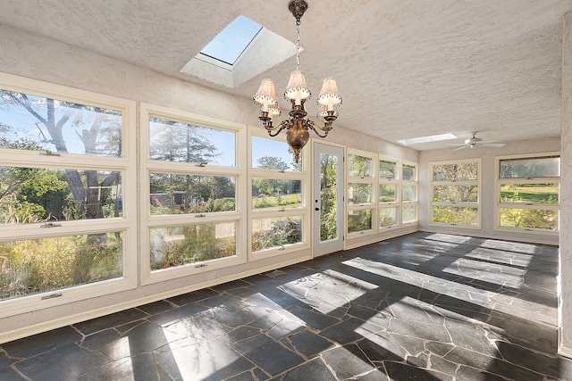 unfurnished sunroom featuring ceiling fan with notable chandelier