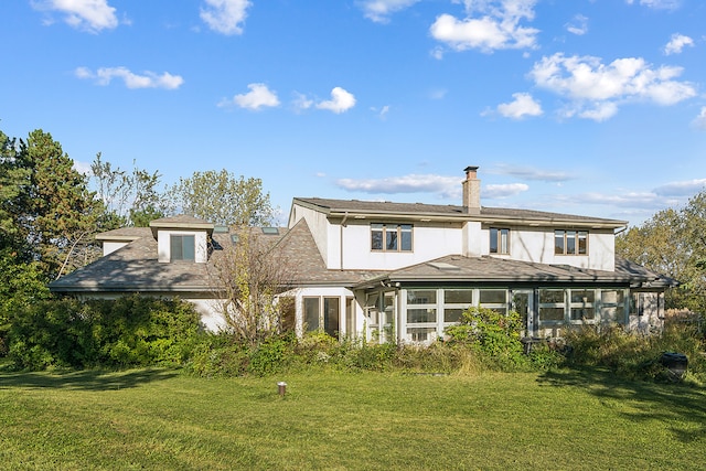 rear view of property with a yard