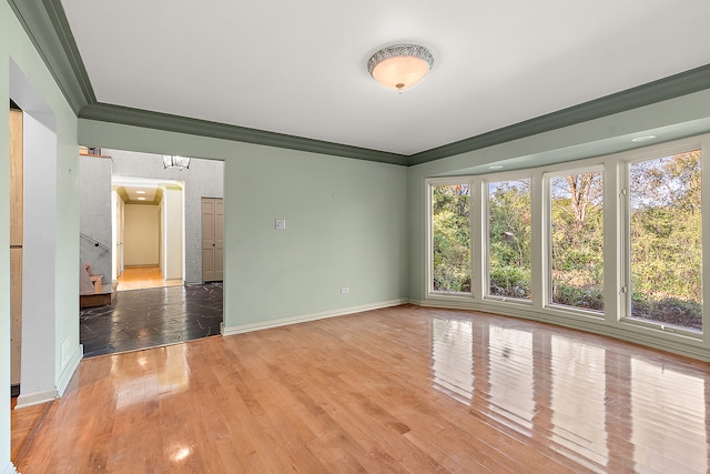 empty room featuring crown molding and hardwood / wood-style floors