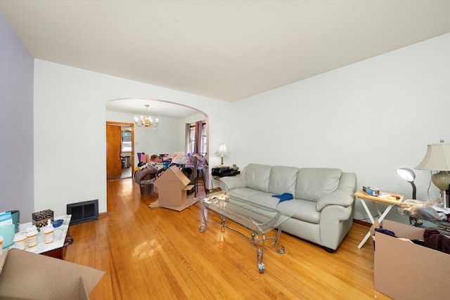 living room featuring an inviting chandelier and light hardwood / wood-style floors