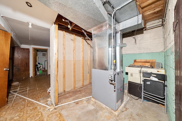 utility room featuring heating unit