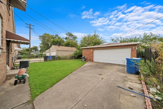 garage with a lawn and central air condition unit