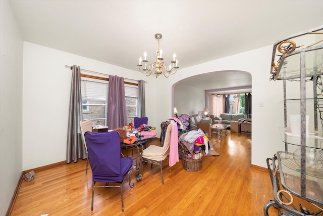 dining room with hardwood / wood-style flooring, a chandelier, and a wealth of natural light