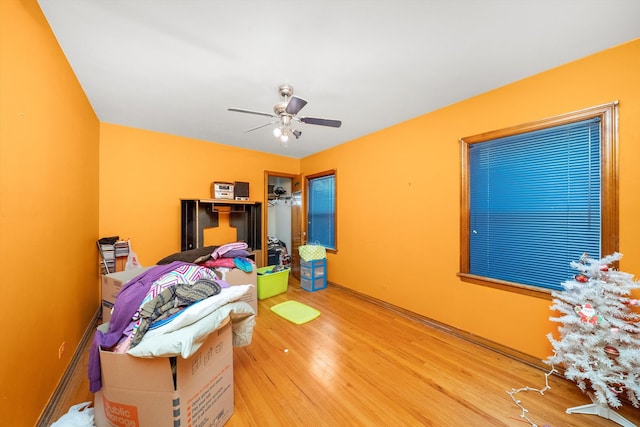 bedroom with ceiling fan and hardwood / wood-style floors