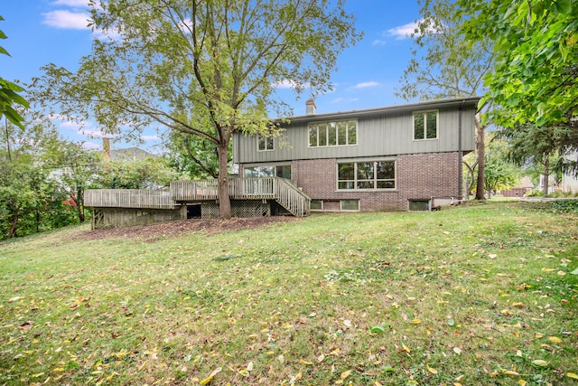 back of house with a wooden deck and a lawn