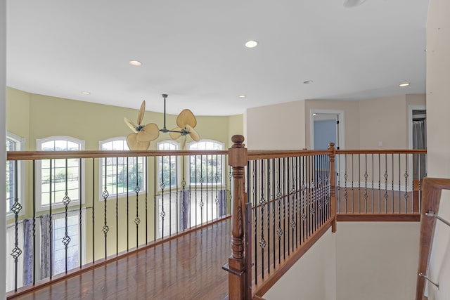 hall with wood-type flooring and an inviting chandelier