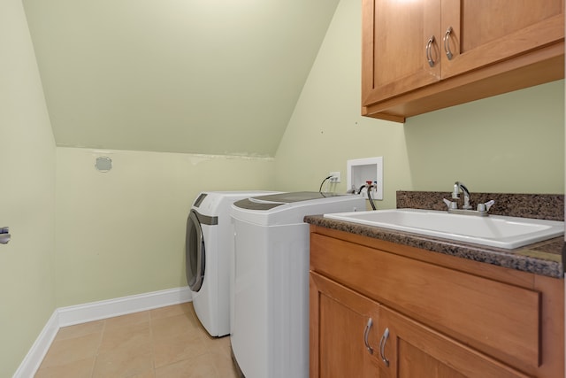 laundry area with light tile patterned floors, separate washer and dryer, cabinets, and sink