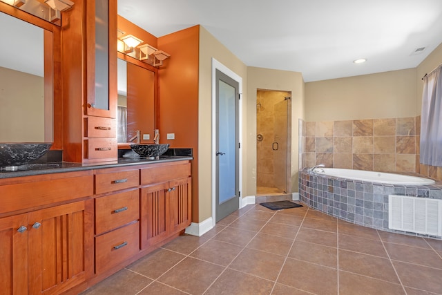 bathroom featuring vanity, plus walk in shower, and tile patterned floors