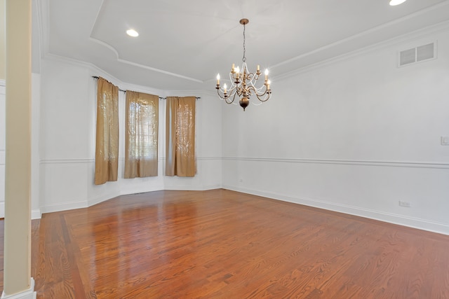 unfurnished room with crown molding, an inviting chandelier, and hardwood / wood-style flooring