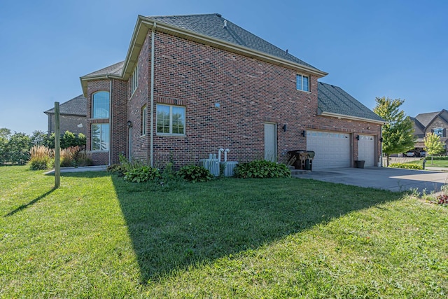 view of property exterior featuring a lawn and a garage