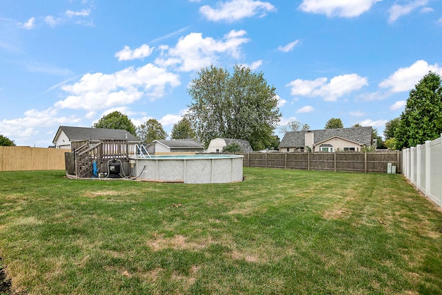 view of yard with a fenced in pool