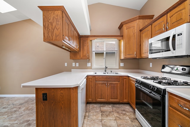 kitchen with white appliances, kitchen peninsula, vaulted ceiling, and sink