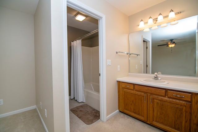 bathroom featuring shower / bath combo with shower curtain, ceiling fan, and vanity