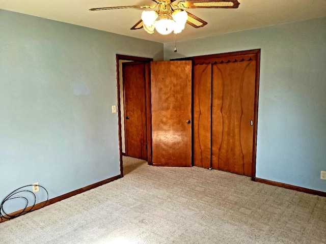 unfurnished bedroom with ceiling fan, a closet, and carpet flooring