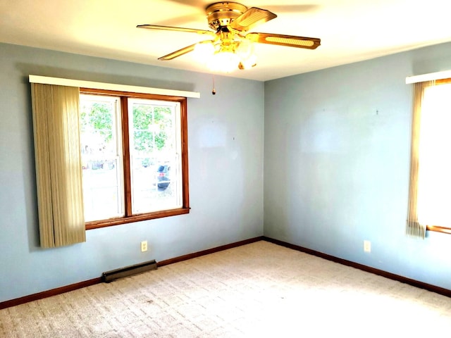 spare room featuring ceiling fan and a baseboard radiator