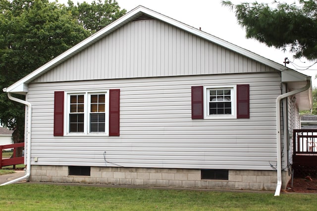 view of home's exterior featuring a lawn and a wooden deck