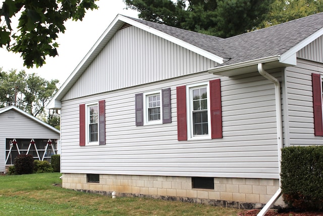 view of side of property with a yard