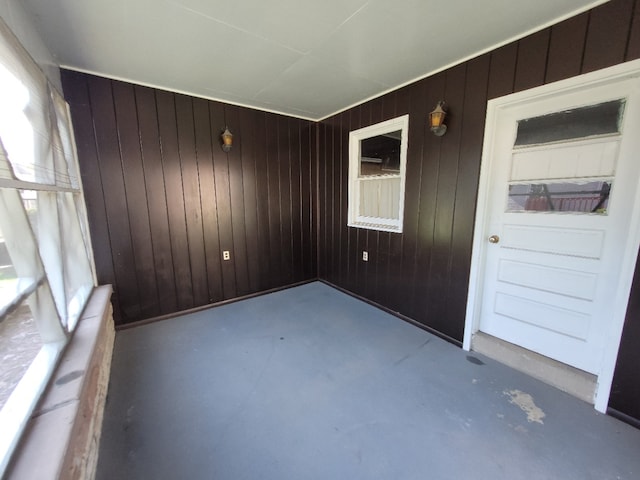 interior space featuring wood walls and concrete flooring