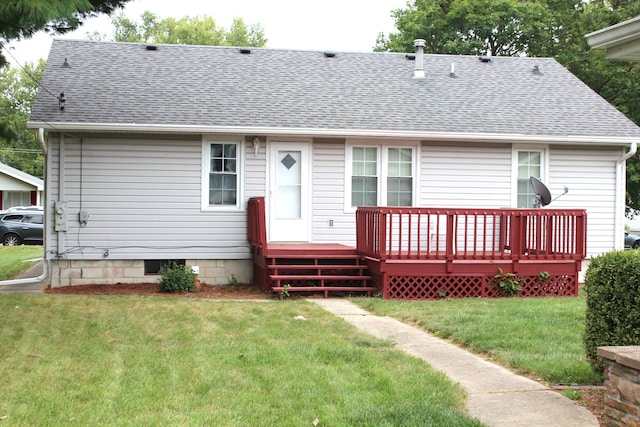 back of house featuring a wooden deck and a yard